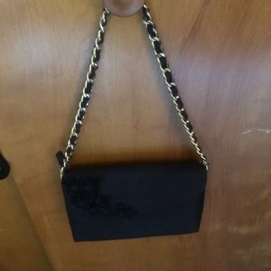 Black fabric clutch the gold braided strap